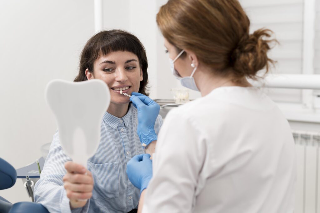 female-patient-looking-mirror-dentist-s-office